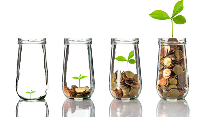 4 jars with a plant growing out of coins